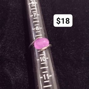 Purple oval orb style stone ring set in silver tone